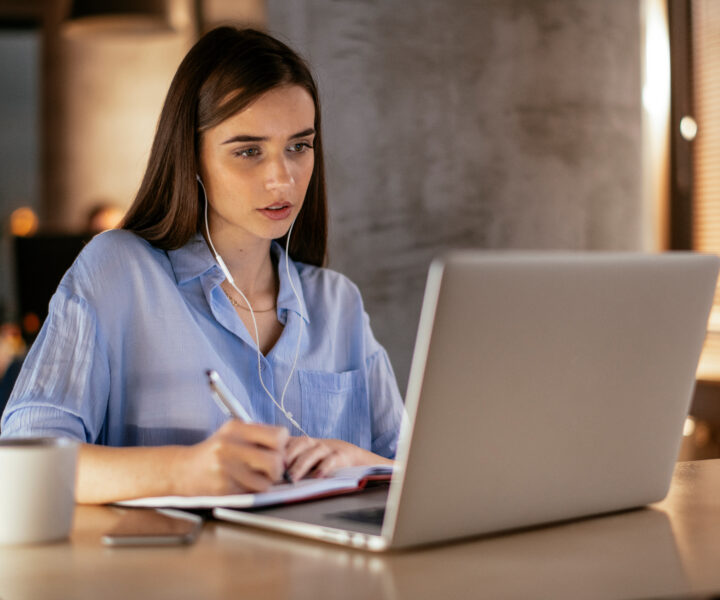 A person sitting at a table with a laptop.