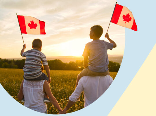 A couple of children holding the Canadian flag.