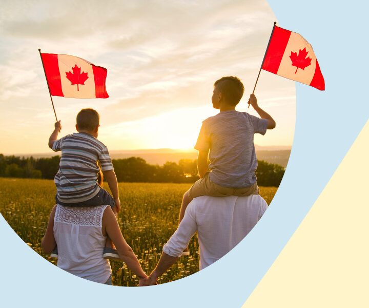 A couple of children holding the Canadian flag.