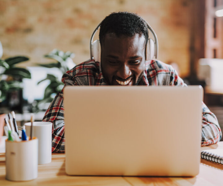 A person sitting at a desk with a laptop computer.