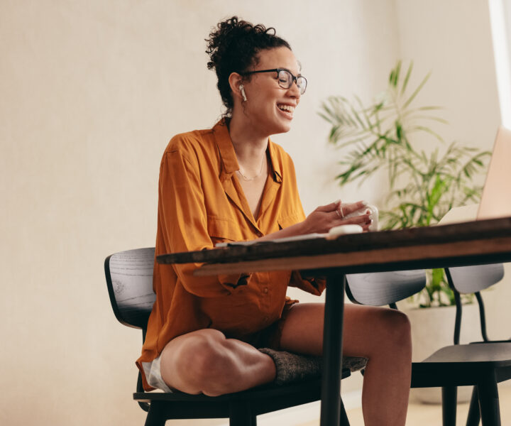 A person sitting at a table with a laptop.