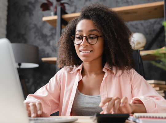 A person sitting at a desk with a laptop.