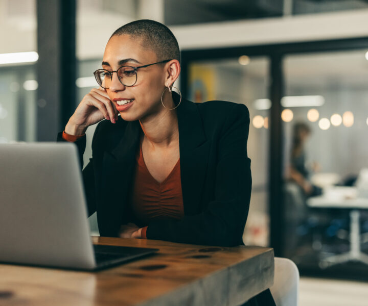 A person sitting at a table with a laptop.