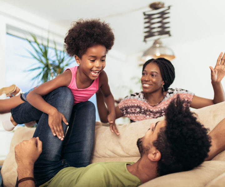 A family sitting on a couch together.