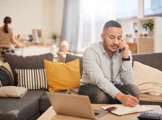 A person sitting at a table with a laptop.