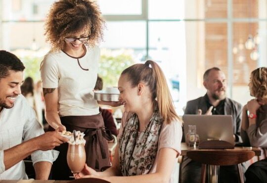 A person and a person are talking in a cafe.