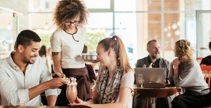 A person and a person are talking in a cafe.