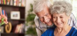 A person and person are smiling together in a living room.