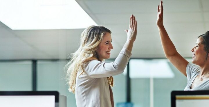 A person holding her hand up to her face.