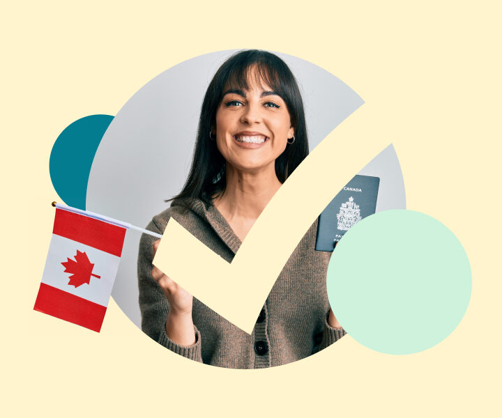 A person is holding a Canadian flag made of paper.