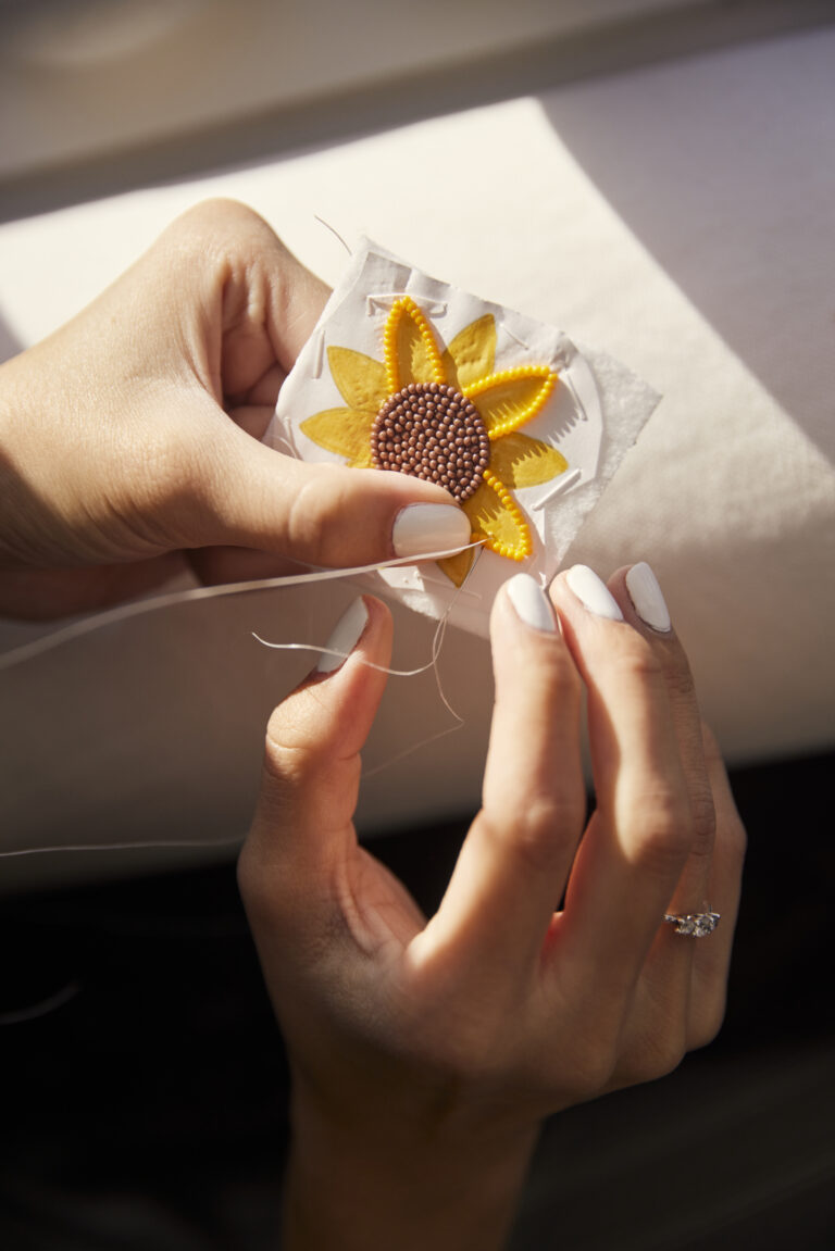 A person is weaving a flower