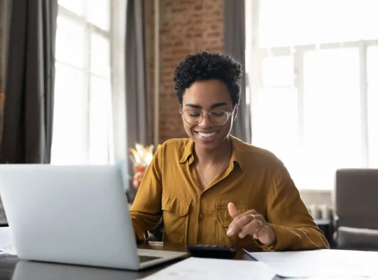 A person sitting at a desk with a laptop.