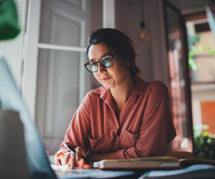 A person sitting at a desk with a laptop.