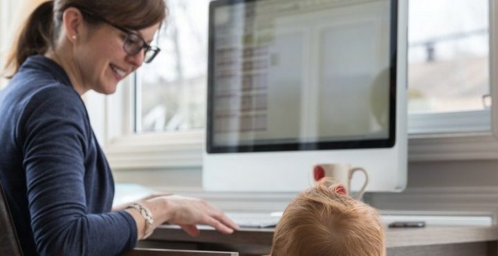 A person sitting at a desk with a child.