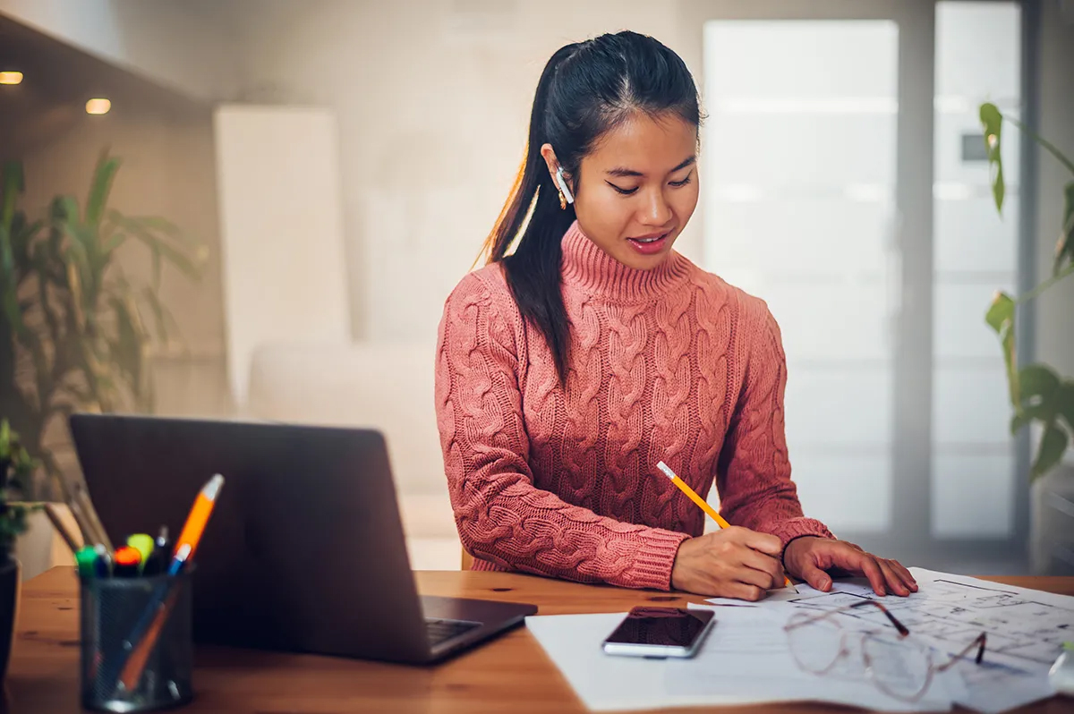 A person sitting at a desk with a laptop.