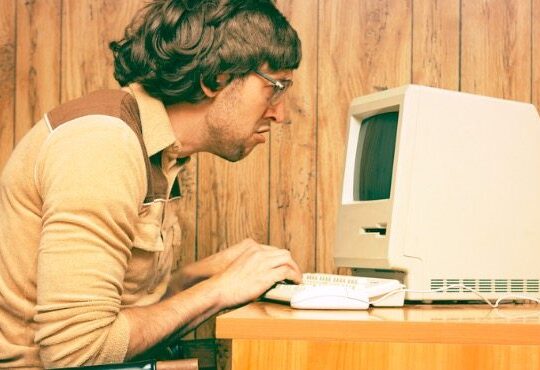 A person sitting in front of a laptop computer.