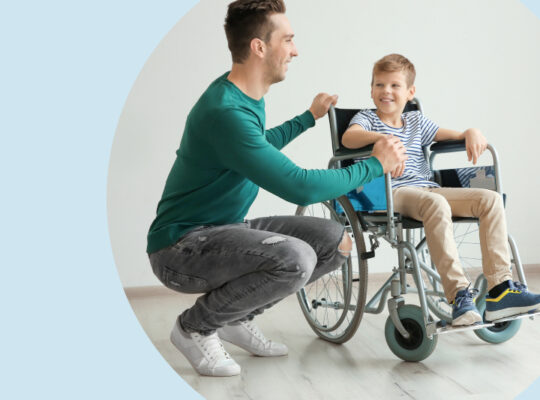 A person sitting on a chair with a child in a wheel chair.