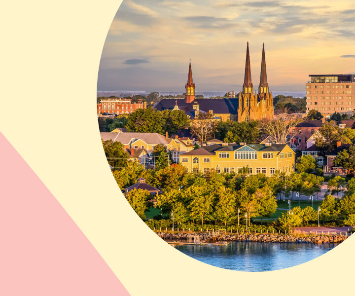 A city view of a pink bridge and a pink clock tower.