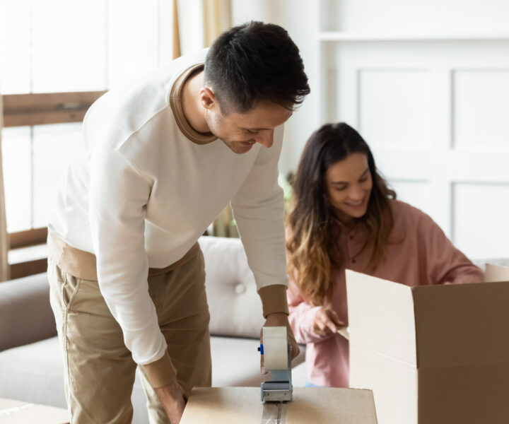 A couple is happily packing their boxes.