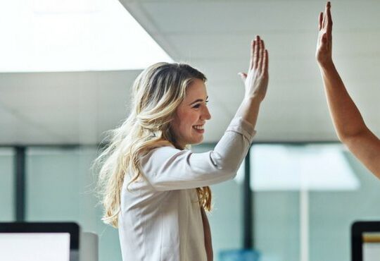 A person holding her hand up to her face.