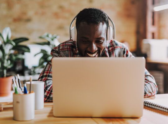 A person sitting at a desk with a laptop computer.