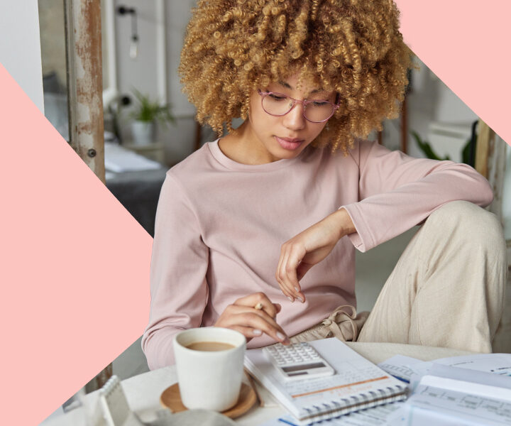 A person is sitting at a table with a book and a cup of coffee.