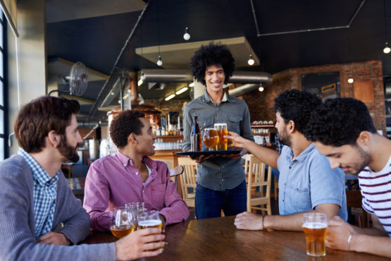 A group of people celebrating in a restaurant.