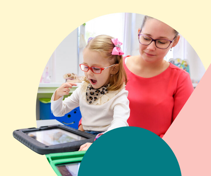 A person and a child are looking at a tablet.