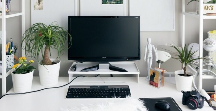 A computer desk with a keyboard, mouse and monitor.