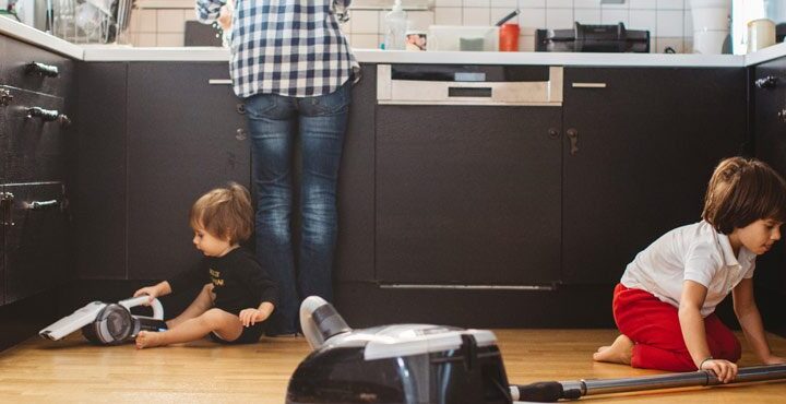 A person and a child are in the kitchen.