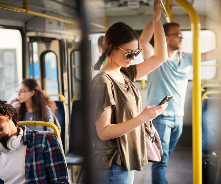 A group of people standing on a bus.