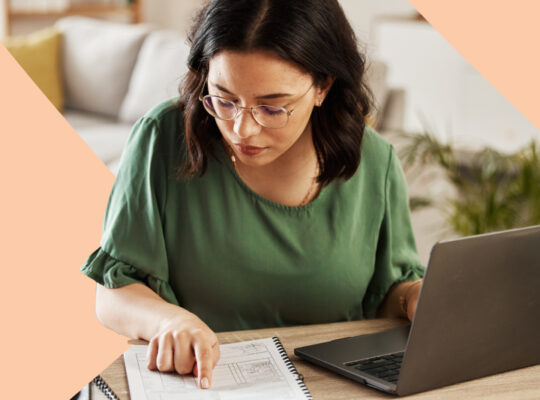 A person sitting at a table with a laptop.