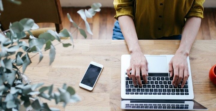 A female blogger writing on the laptop.