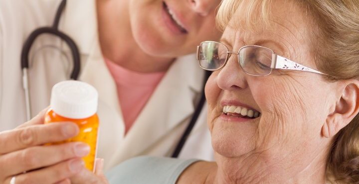 A person is reading the medicine instructions.