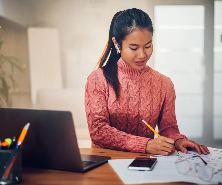 A person sitting at a desk with a laptop.