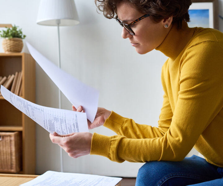 A person sitting at a desk with a papers.