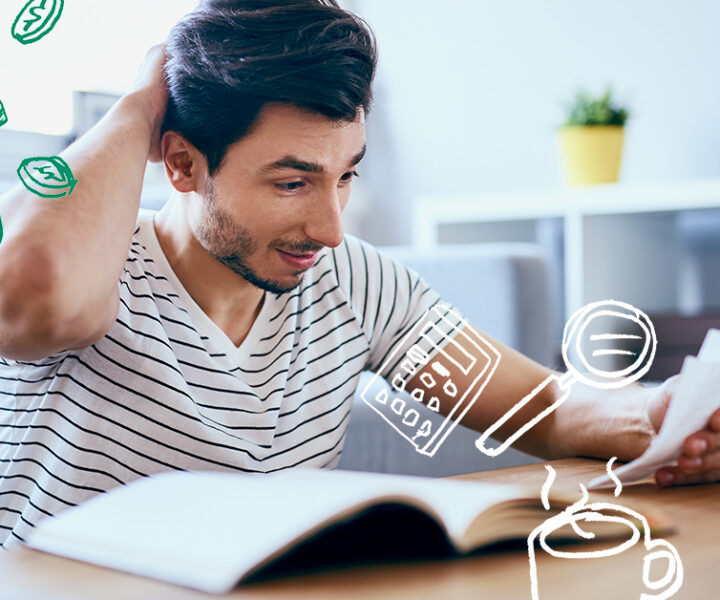 A person sitting in front of a book on a table.