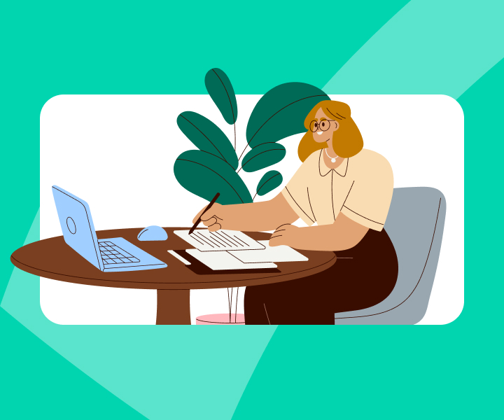 A person sitting on a chair with documents and a laptop on the table