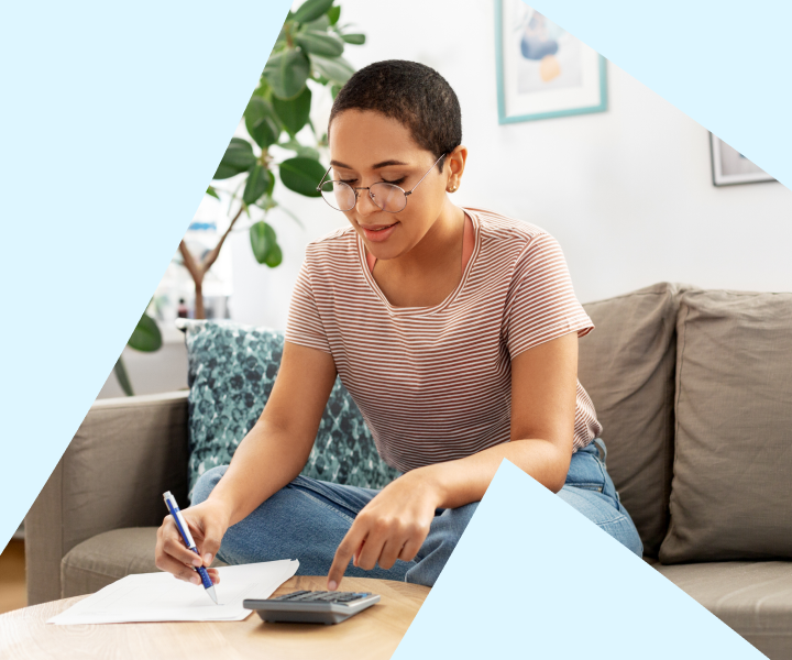 A person sitting on a couch with a pen and a paper.