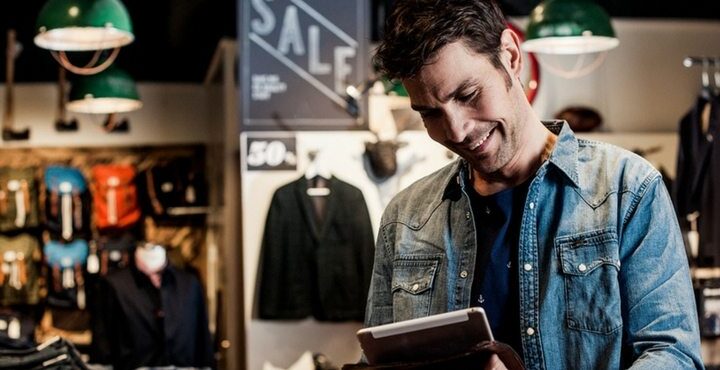 A person is standing in a clothing store.