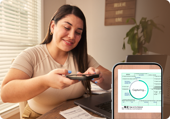 An image of a woman taking a picture of their tax form.