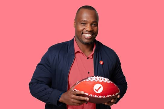 Meet Demi, a TurboTax Expert holding a TurboTax football.