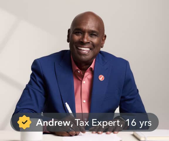 Andrew, a tax expert with 16 years of experience, greets a user with a smile and a wave.