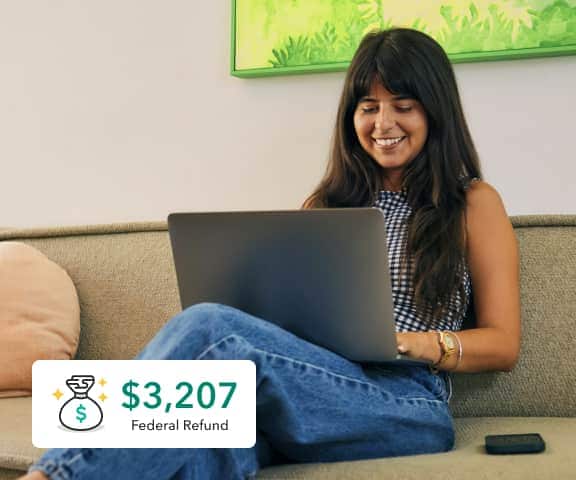 A young woman answers questions online to help receive her maximum refund.