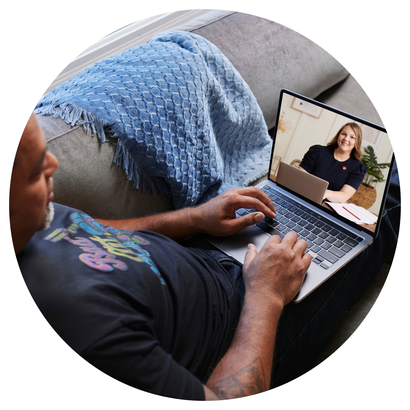 TurboTax customer is seated with their laptop open, and the screen shows a Tax expert on a one-way video call.