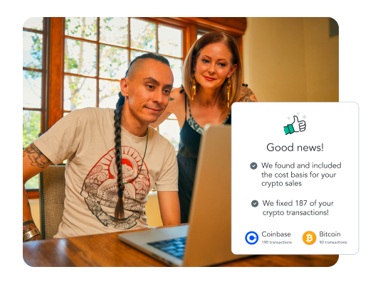 TurboTax Customer Raven and his partner smile as they look down at their laptop.