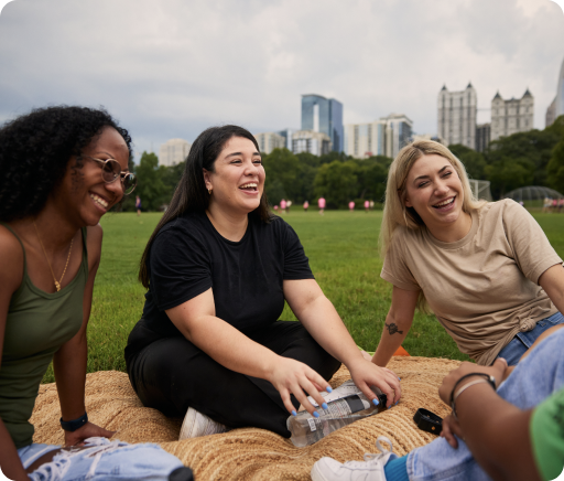 TurboTax customer Vanessa laughs outdoors with her friends.