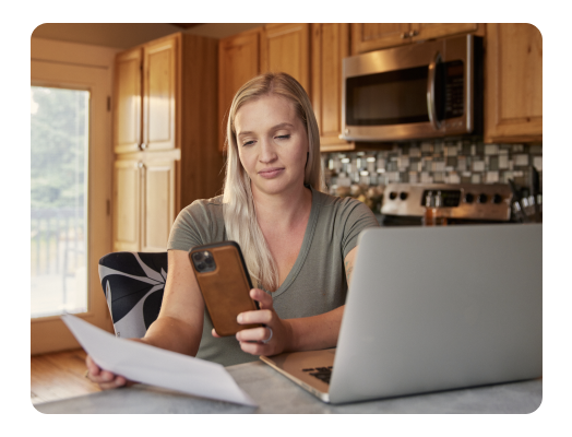 TurboTax customer Sarah uses her phone to take a picture of tax documents.