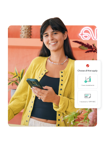 TurboTax customer Elizabeth smiles as she uses her smartphone to file.