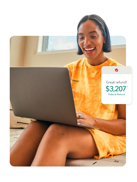 TurboTax customer Stepha smiles as she looks at her laptop.